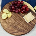 Round handcrafted walnut charcuterie serving board made from solid East Indian walnut